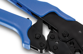 A close-up view of a crimping tool with blue handles. The tool has a black metal mechanism with several bolts and a spring visible. The blue handles are ergonomically designed for a comfortable grip.